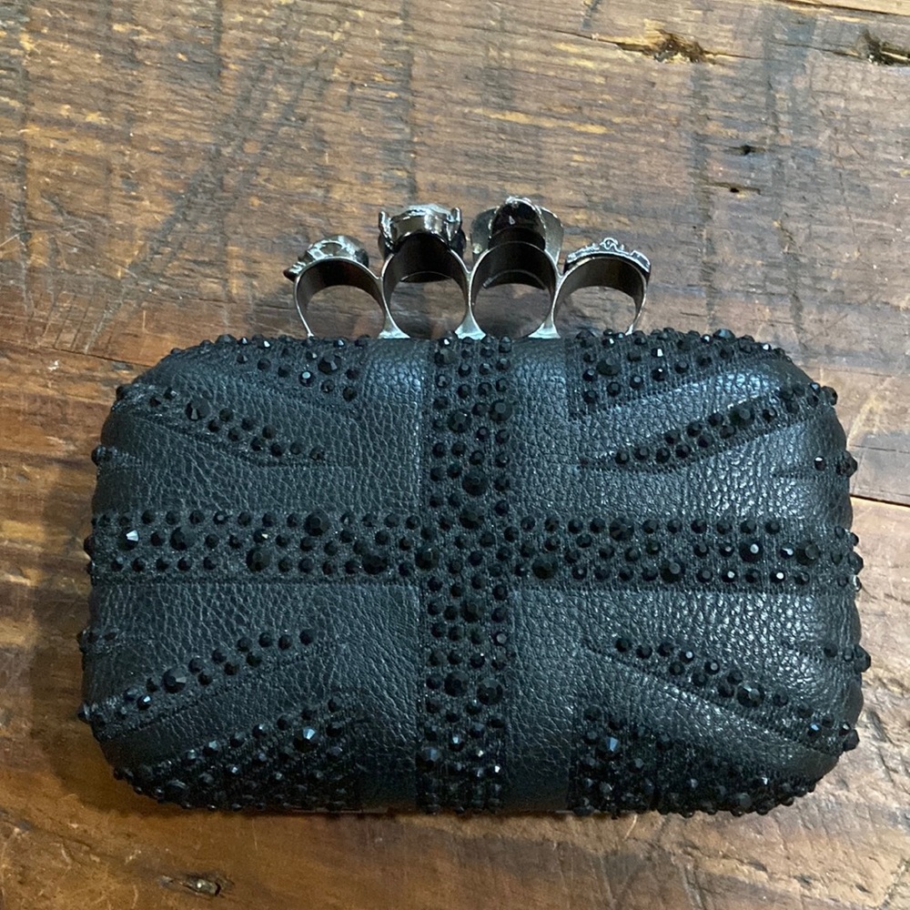 Black hand clutch with skull knuckles